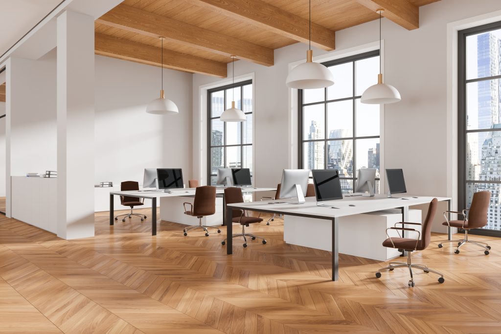 Image générée par IA d'un bureau dans une tour avec des postes de travail en openspace